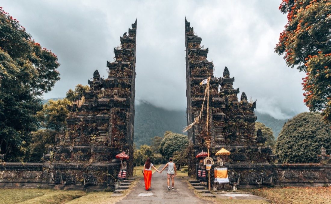 Couple walking through the Handara Gate in Bali, Indonesia